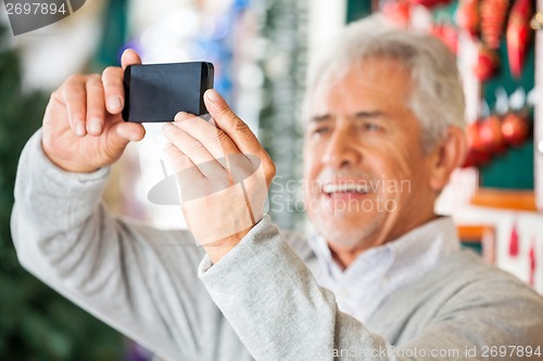 Image of Man Photographing In Christmas Store