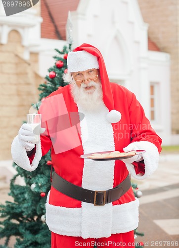 Image of Santa Claus With Cookies And Milk