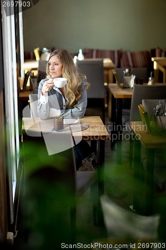 Image of Woman in Cafe Day Dreaming