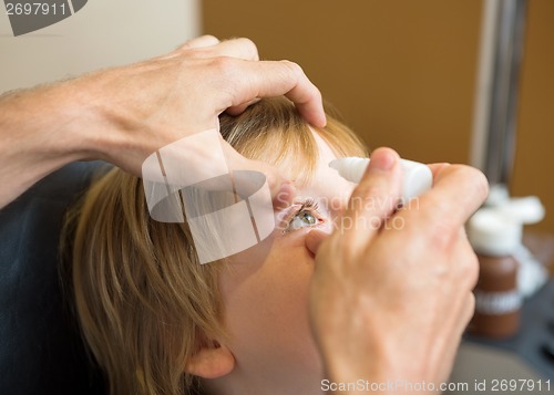 Image of Optometrist Hands Putting Eye Drops In Patients Eye