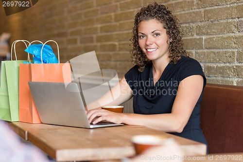 Image of Woman in Cafe with Computer