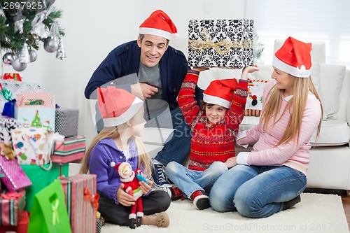 Image of Playful Family With Christmas Gifts