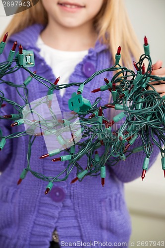 Image of Girl Holding Tangled Fairy Lights