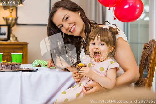 Image of Happy Woman With Daughter Eating Birthday Cake