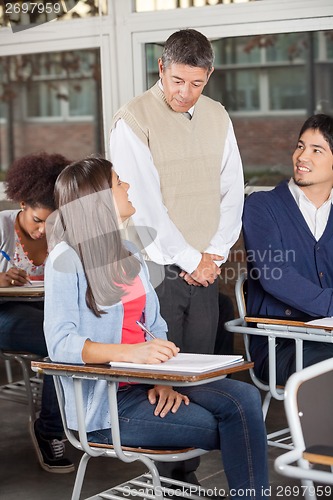 Image of Students Looking At Teacher While Giving Exam In Classroom