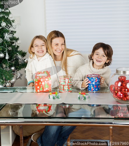 Image of Happy Children And Mother With Christmas Presents