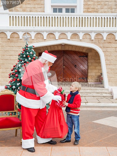 Image of Boy Receiving Gift From Santa Claus