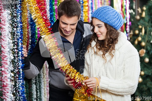 Image of Couple Shopping For Tinsels At Store