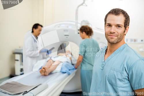 Image of Nurse With Colleague And Radiologist Preparing Patient For CT Sc