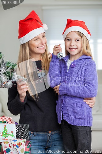 Image of Girl With Mother Decorating Christmas Tree
