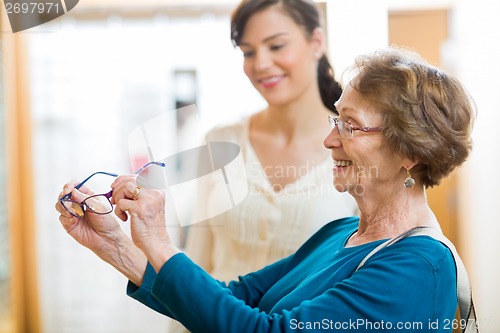 Image of Senior Woman Holding New Glasses In Store
