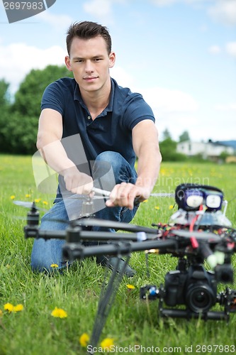 Image of Engineer Fixing Propeller Of UAV Spy Drone