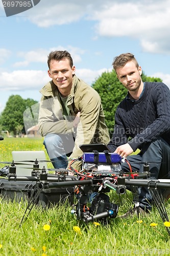Image of Technicians With Laptop And Digital Tablet By UAV