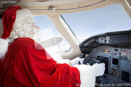 Image of Santa In Cockpit Flying Private Jet