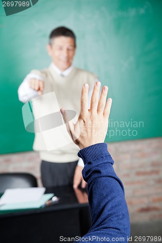 Image of Student's Hand With Professor Pointing At Him In Classroom