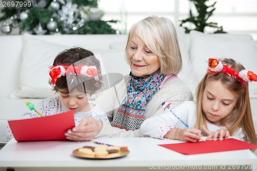 Image of Senior Woman With Siblings Writing Letters To Santa Claus