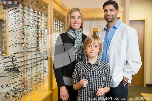 Image of Boy With Optometrist And Mother In Store