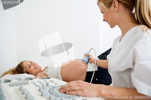 Image of Technician Scanning Pregnant Woman's Belly