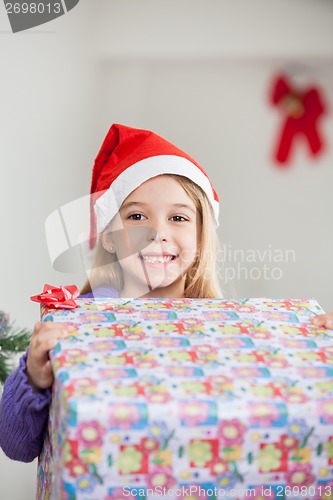 Image of Happy Girl Holding Christmas Gift
