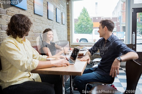 Image of Friends Spending Leisure Time In Cafe