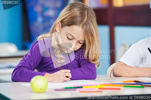 Image of Girl With Sketch Pen Drawing In Kindergarten