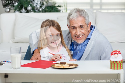 Image of Happy Grandfather And Girl With Cardpaper