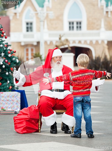 Image of Boy About To Embrace Santa Claus