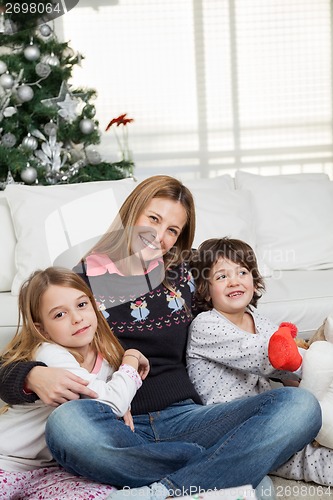 Image of Mother And Children At Home During Christmas