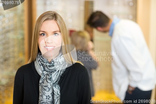 Image of Smiling Woman With Optometrist And Son In Background