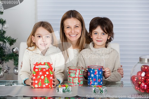 Image of Mother And Children With Christmas Presents