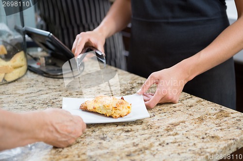 Image of Waitress Serving Sweet Food To Woman