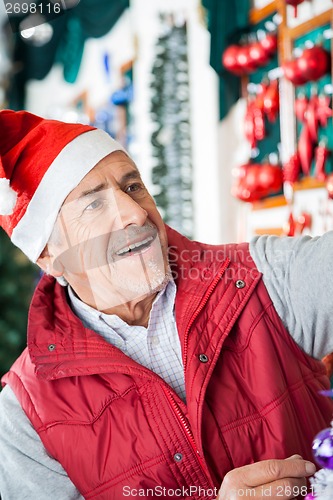 Image of Senior Male Owner Working At Christmas Store