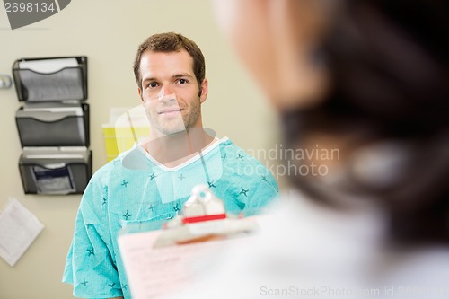 Image of Smiling Patient Looking At Doctor