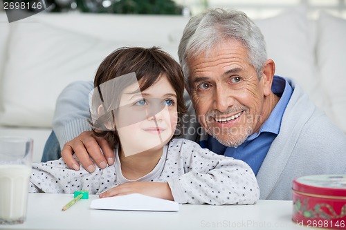 Image of Boy And Grandfather With Envelope Smiling