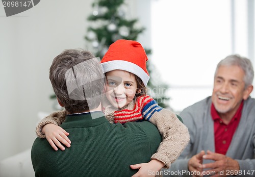 Image of Happy Boy Embracing Father During Christmas