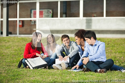 Image of Students Sitting Together On Grass At University Campus