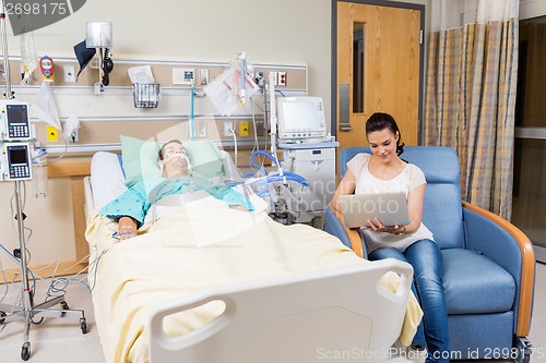 Image of Woman With Digital Tablet Sitting By Patient
