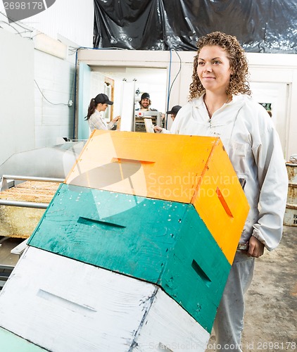 Image of Beekeeper Pushing Trolley Of Stacked Honeycomb Crates