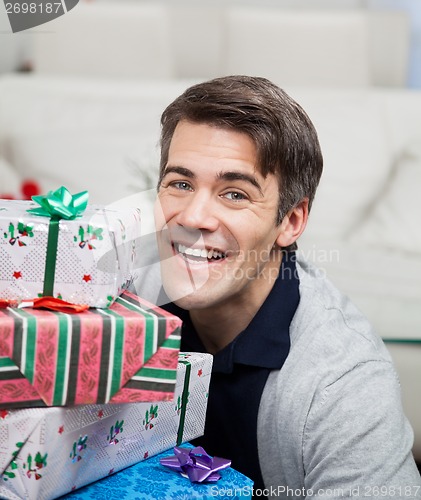 Image of Smiling Mid Adult Man With Christmas Gifts