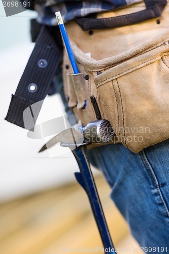 Image of Hammer Hanging In Tool Belt Of Carpenter