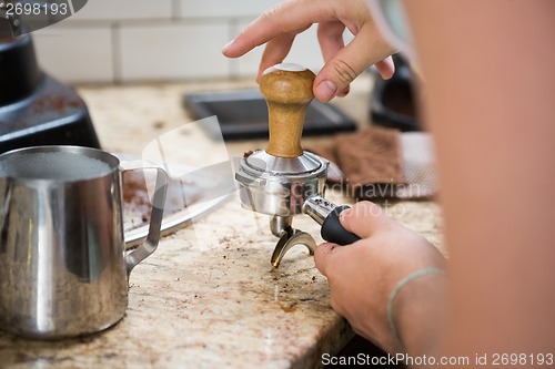 Image of Barista Tamping Coffee