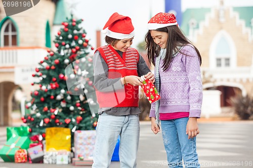 Image of Happy Friends Opening Gift