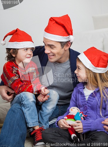 Image of Father And Children In Santa Hats