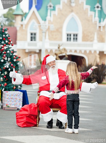 Image of Santa Claus About To Embrace Girl
