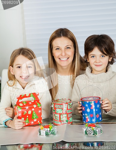 Image of Happy Woman And Children With Christmas Gifts