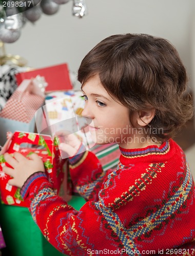 Image of Boy Stacking Christmas Gifts