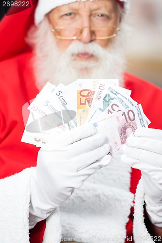 Image of Santa Claus Holding Money