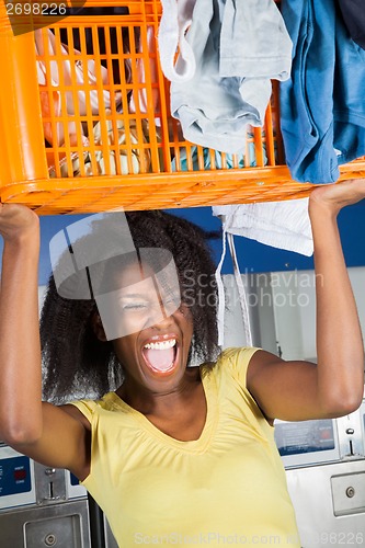 Image of Woman Carrying Basket Of Dirty Clothes