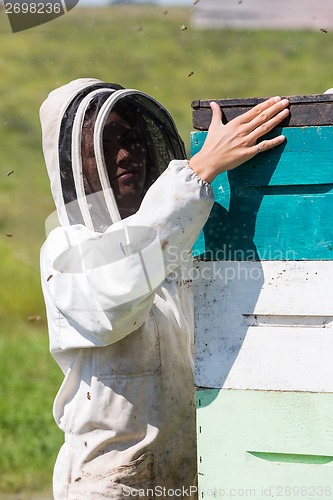 Image of Female Beekeeper Working At Apiary