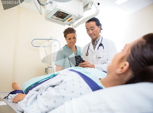 Image of Medical Team Using Digital Tablet In Examination Room